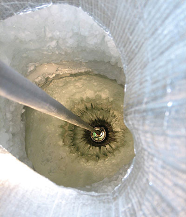 A DOM being lowered into the ice.